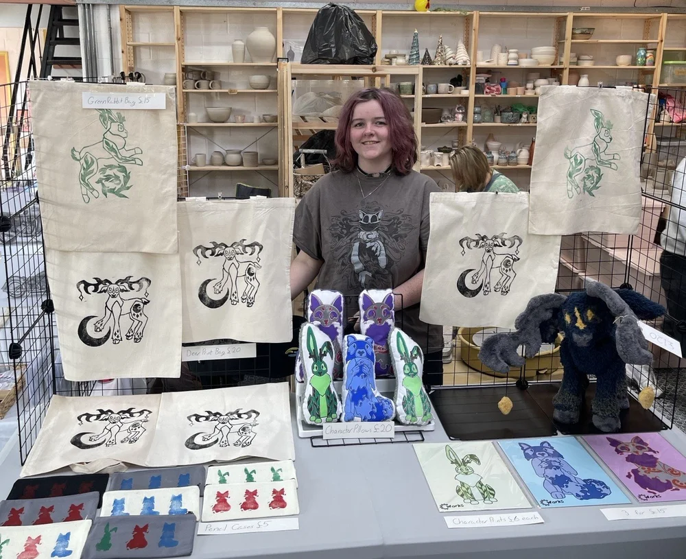 Current student Ella Grace-Wells selling her art work at Claire's House